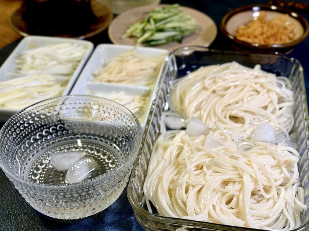 半田そうめんと透明醤油の冷たいめんつゆ、薬味を並べた食卓