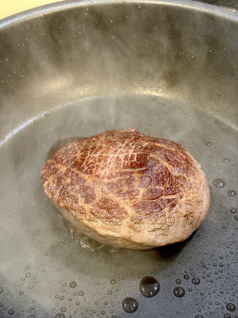 低温調理後の黒毛和牛ランプをフライパンで表面だけ焼き色を付ける工程